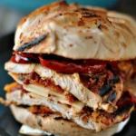 Grilled Smoked Chicken Sandwich with Roasted Red Peppers, Mozzarella, and Red and Yellow Pepper Pesto